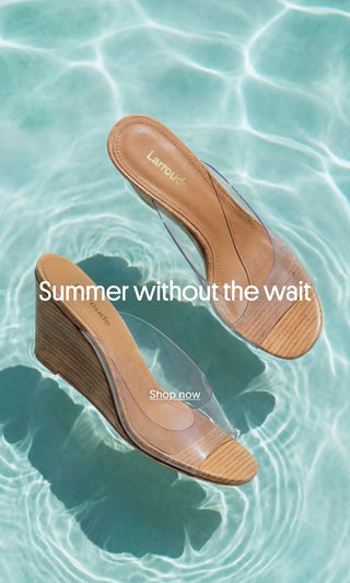 Larroudé transparent wedge sandals floating on turquoise pool water, showcasing the summer collection.