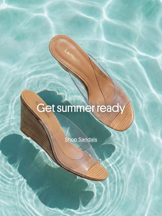 Two Larroudé tan leather wedge sandals with clear PVC straps floating on rippling turquoise pool water, with text overlay reading 'Get summer ready' and a 'Shop Sandals' call-to-action link