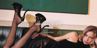 Woman reclining on a green velvet sofa wearing black patent platform heels from the Larroudé by Nicolò B. collaboration.