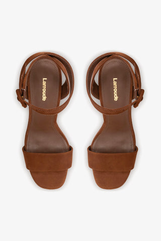 Pair of brown sandals with 'Larouche' branding on a white background