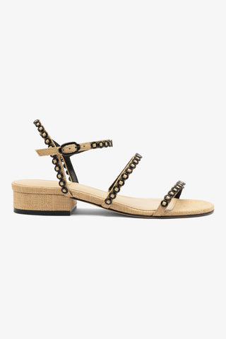 Beige sandal with studded details on a white background