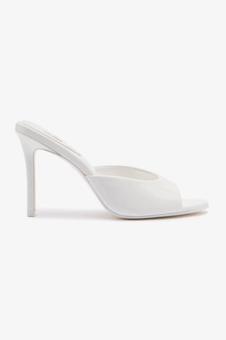 A single white high heel mule with an open toe and stiletto heel, isolated on a white background.