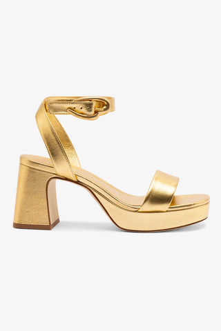 Gold high-heeled platform sandal on a white background