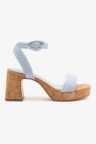 A blue denim and natural cork platform sandal with an adjustable ankle strap and a block heel.