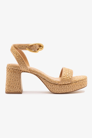 A beige platform sandal with ankle strap and block heel made of raffia fabric.