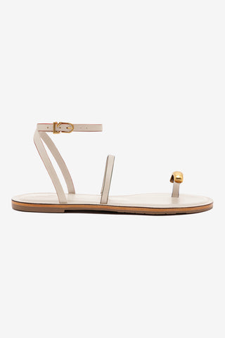 White sandal with gold accents on a white background